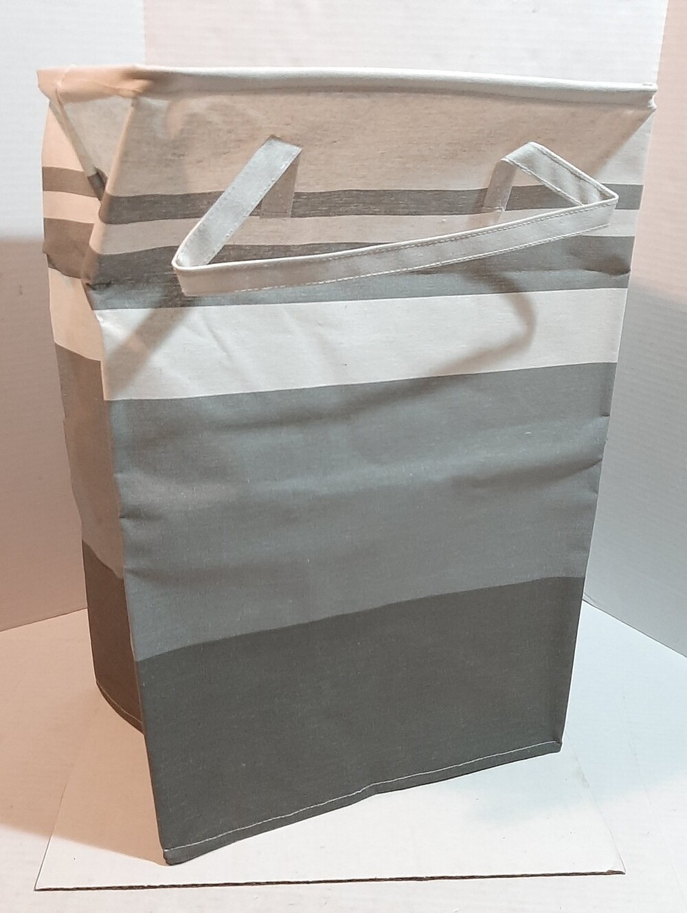 New collapsible fabric laundry hamper with a gradient gray striped pattern